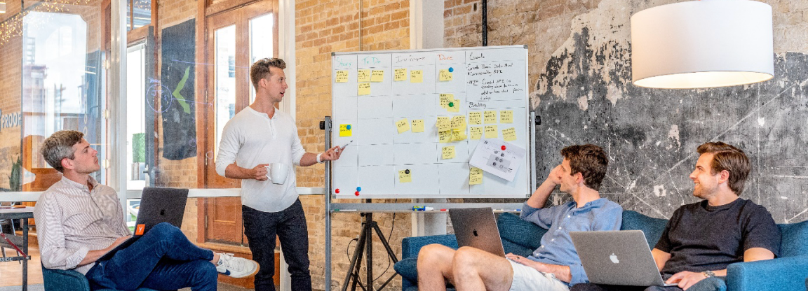 People working around a whiteboard